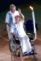 Betty Cuthbert on wheelchair pushed by Raelene Boyle